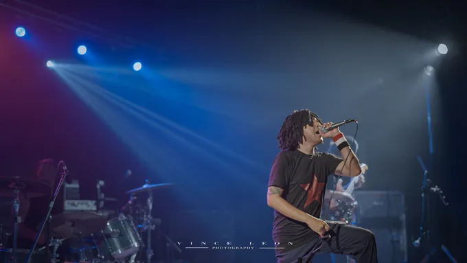 Vocalist onstage under blue lights