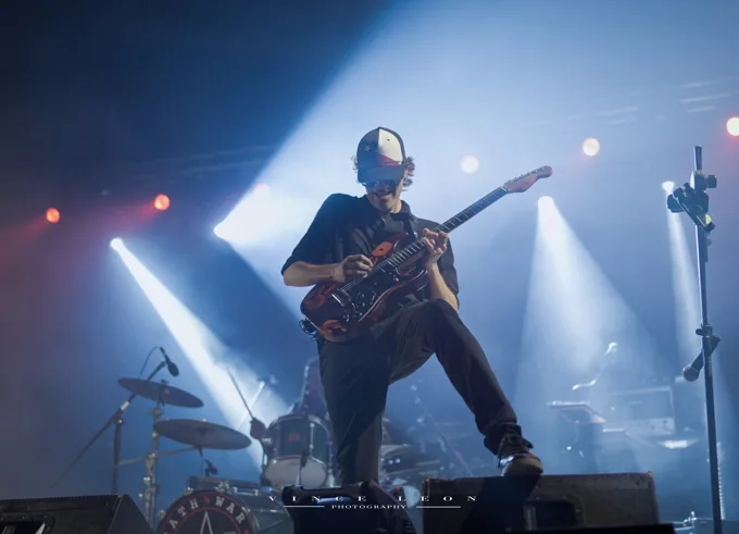 Guitarist taking a wide stance onstage