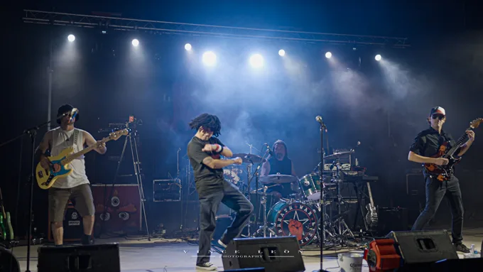 Wide view of the full band performing