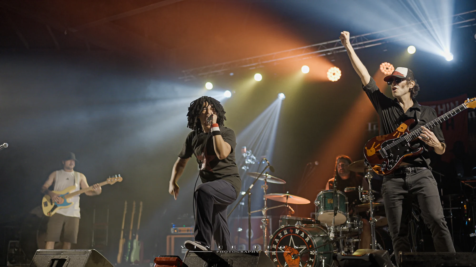 War Within a Breath performing live, with the bassist, vocalist, drummer, and guitarist visible across the stage